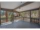 Spacious covered patio with string lights overlooking a serene wooded landscape at 29691 Fairway Dr, Evergreen, CO 80439