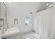 All-white bathroom featuring a pedestal sink and a shower with a curtain at 1526 S Gaylord St, Denver, CO 80210