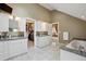 Spacious bathroom with double sinks, vanity, walk-in closet, and a luxurious bathtub at 1526 S Gaylord St, Denver, CO 80210
