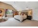 Spacious bedroom with vaulted ceilings, large bed, and windows at 1526 S Gaylord St, Denver, CO 80210