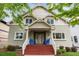 Charming home with a welcoming front porch, complete with red stairs, and blue chairs at 1526 S Gaylord St, Denver, CO 80210