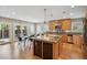 Bright kitchen with stainless steel appliances, wooden cabinets, and views of the outdoor patio at 1526 S Gaylord St, Denver, CO 80210