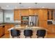 Modern kitchen with stainless steel appliances, granite counters, and an island with bar seating at 1526 S Gaylord St, Denver, CO 80210
