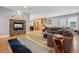 Open-concept living room featuring a stone fireplace, wood floors, and ample natural light at 1526 S Gaylord St, Denver, CO 80210