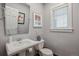 Stylish half-bathroom featuring a pedestal sink, and a modern mirror at 1526 S Gaylord St, Denver, CO 80210