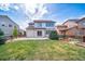 The backyard has a large green lawn and patio area at 21482 E Idyllwilde Dr, Parker, CO 80138