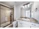 Bathroom showcasing a tiled shower, vanity with granite counters, and white cabinets at 21482 E Idyllwilde Dr, Parker, CO 80138