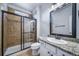 Bathroom featuring a shower stall with glass doors, granite counters, and white vanity at 21482 E Idyllwilde Dr, Parker, CO 80138