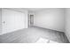 Neutral bedroom featuring gray carpet, closet doors, and a white door leading to another room at 21482 E Idyllwilde Dr, Parker, CO 80138