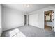 Bedroom with neutral carpet, white walls, closet doors, and ensuite bathroom at 21482 E Idyllwilde Dr, Parker, CO 80138