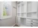 Custom closet featuring built-in shelving, drawers, and ample storage space for organizing clothes and accessories, with natural light at 21482 E Idyllwilde Dr, Parker, CO 80138