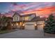 Charming home with a covered front porch, three-car garage, and well-maintained landscaping at 21482 E Idyllwilde Dr, Parker, CO 80138