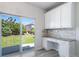 Office space with white cabinets, granite counters, and sliding glass door to the backyard at 21482 E Idyllwilde Dr, Parker, CO 80138