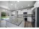 Gourmet kitchen featuring a large center island with granite countertops, stainless steel appliances, and ample cabinet space at 21482 E Idyllwilde Dr, Parker, CO 80138