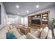 Comfortable living room with a large built-in entertainment center, plush seating, and bright lighting at 21482 E Idyllwilde Dr, Parker, CO 80138