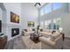 Spacious living room with a soaring ceiling, large windows, fireplace, and comfortable seating at 21482 E Idyllwilde Dr, Parker, CO 80138
