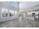Open-concept living area flows into a modern kitchen with a large island, stainless appliances, and ample counter space at 21482 E Idyllwilde Dr, Parker, CO 80138