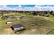 Aerial view of a barn and pastures, surrounded by fencing at 17800 E Hinsdale Ave, Foxfield, CO 80016