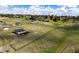Aerial view showcasing fenced in land and outbuildings at 17800 E Hinsdale Ave, Foxfield, CO 80016