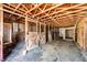 Barn interior with wooden stalls, doors, and hay-covered floor at 17800 E Hinsdale Ave, Foxfield, CO 80016