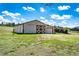 Spacious barn with a sliding door and attached garage at 17800 E Hinsdale Ave, Foxfield, CO 80016