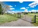 Gated access to property with barn and pasture beyond at 17800 E Hinsdale Ave, Foxfield, CO 80016