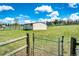 Barn with metal sliding doors and fenced in pasture at 17800 E Hinsdale Ave, Foxfield, CO 80016