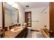 Full bathroom with vanity, mirror, tile floor, and tub shower combo at 17800 E Hinsdale Ave, Foxfield, CO 80016