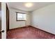 This bedroom features a window with a neighborhood view and plush carpeting at 17800 E Hinsdale Ave, Foxfield, CO 80016