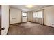 This room features two windows providing natural light and neutral carpet at 17800 E Hinsdale Ave, Foxfield, CO 80016