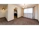 Dining room featuring plush carpet, neutral paint, and a vintage chandelier and window at 17800 E Hinsdale Ave, Foxfield, CO 80016