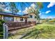 Exterior of the home with a backyard deck and lush lawn at 17800 E Hinsdale Ave, Foxfield, CO 80016