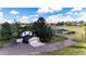 Two-story home with a two-car garage and outbuildings on acreage at 17800 E Hinsdale Ave, Foxfield, CO 80016