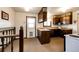Kitchen with wood cabinets, standard appliances, and access to outdoor space at 17800 E Hinsdale Ave, Foxfield, CO 80016