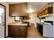 Functional kitchen with wood cabinets, standard appliances, and lots of counter space at 17800 E Hinsdale Ave, Foxfield, CO 80016