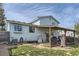 Backyard with patio cover, well-maintained lawn, and home's light-blue siding at 19485 E Purdue Pl, Aurora, CO 80013