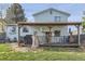 Spacious backyard with a covered deck area, well-kept lawn, and light-blue siding at 19485 E Purdue Pl, Aurora, CO 80013