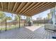 An outdoor covered patio has a wood-style ceiling and a decorative patterned wood floor at 19485 E Purdue Pl, Aurora, CO 80013