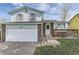 Charming two-story home featuring a brick and siding exterior, a well-kept lawn, and an attached garage at 19485 E Purdue Pl, Aurora, CO 80013