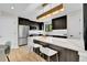 Modern kitchen with stainless steel appliances, dark cabinets and a waterfall island at 2164 S Ash St, Denver, CO 80222