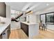 Open kitchen featuring quartz island, wood cabinets, steel appliances, and an eat-in dining area at 2164 S Ash St, Denver, CO 80222