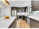 Modern kitchen with stainless steel appliances, dark cabinets and a waterfall island at 2164 S Ash St, Denver, CO 80222