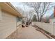 View of the property's backyard highlighting the wooden fence and brick paved driveway at 3127 And 3125 N Raleigh St, Denver, CO 80212