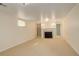 Basement with fireplace, neutral carpet, bright lighting, and built-in shelving at 3127 And 3125 N Raleigh St, Denver, CO 80212