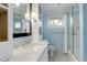 Bathroom with marble vanity, bright lighting, glass shower door, and black and white tile floors at 3127 And 3125 N Raleigh St, Denver, CO 80212