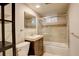 A clean bathroom with glass shower door, modern fixtures, and wood vanity at 3127 And 3125 N Raleigh St, Denver, CO 80212