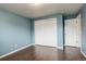 Bedroom with blue walls, hardwood floors, and a closet at 3127 And 3125 N Raleigh St, Denver, CO 80212