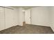 Bedroom featuring neutral carpet, white painted walls, closet, a door, and base trim at 3127 And 3125 N Raleigh St, Denver, CO 80212