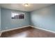 Cozy bedroom with hardwood floors, a window providing natural light, and light blue painted walls at 3127 And 3125 N Raleigh St, Denver, CO 80212