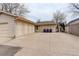 Exterior of the garage with multiple doors and ample parking space on a concrete driveway at 3127 And 3125 N Raleigh St, Denver, CO 80212